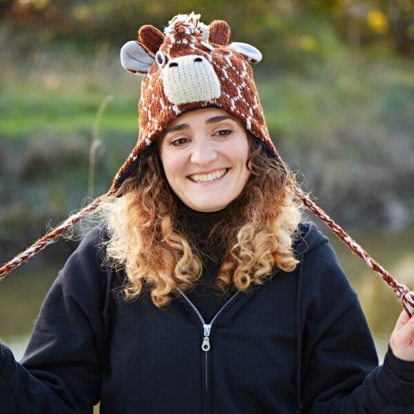 A woman wearing a Fair Trade Giraffe Woollen Animal Hat.