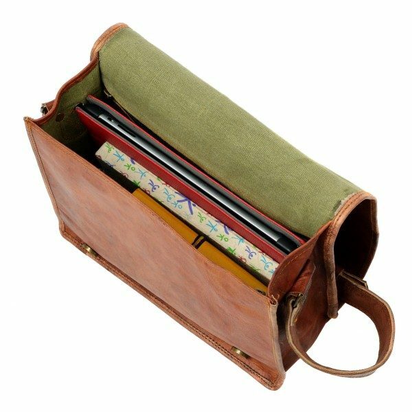 Open Personalised Brown Leather Messenger Bag with eco-friendly green lining, holding a laptop, a colorful notebook, and a yellow book.