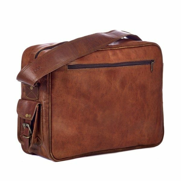 The Personalised Brown Leather Satchel Style Courier Bag features a zippered front pocket, adjustable shoulder strap, and side buckle accents, made from eco-friendly materials and shown against a white background.