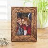 The 6" x 4" Jaraja Natural Mango Wood Photo Frame elegantly displays a picture of two smiling women with long hair—one with straight hair and the other with curly hair. The scene is complemented by a potted plant and dried flowers in the background, enhancing its natural charm.