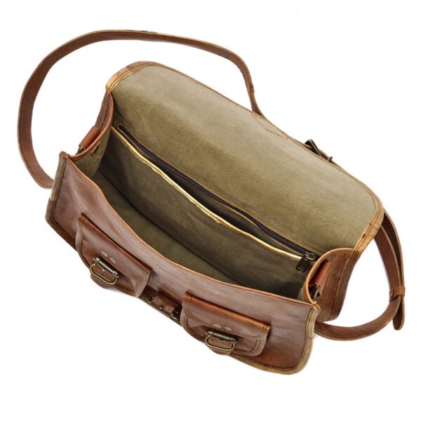 The Personalised Brown Leather Satchel Style Saddle Bag features a long strap, canvas interior, zippered pocket, and two front buckle closures—handmade and eco-friendly for stylish, feel-good carrying.