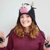 A woman wearing a Fair Trade Cow Woollen Animal Hat.