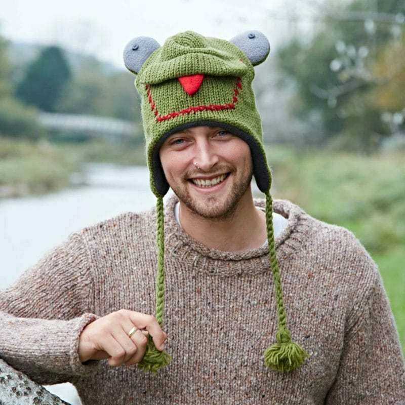 A man wearing a Frog Woollen Animal Hat.