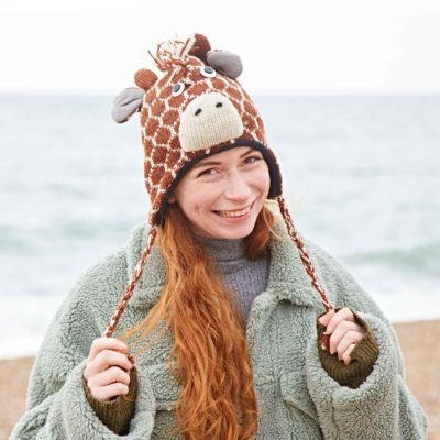 A woman wearing a Fair Trade Giraffe Woollen Animal Hat.