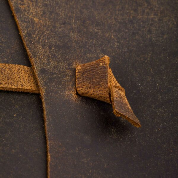 Close-up of the textured surface from the Personalised Buffalo Leather Wraparound Journal, showcasing a folded edge that is ideal for a wraparound journal design. The intricate grain and natural wear enhance its character and charm.