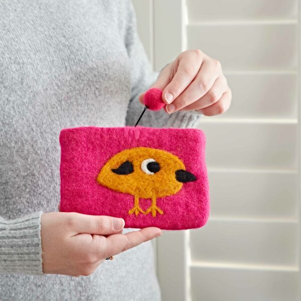 A person holds a Felt Bird Purse, perfect for those who love whimsical bird purses.