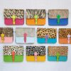 A selection of Multicoloured Crossbody Buckle Bags showcasing vibrant animal prints is laid out in a grid on a light background.