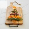 A christmas tree made of cheese and crackers on a Personalised Natural Mango Wood Rectangular Chopping Board.