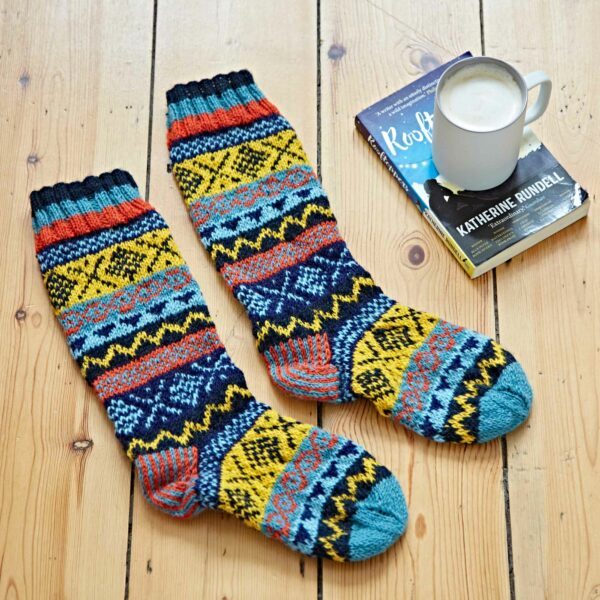 A pair of woollen socks on a wooden floor.