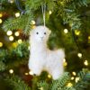 A white Felt Alpaca Christmas Decoration hanging from a tree.