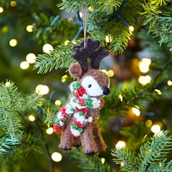 A Felt Reindeer Christmas Decoration hangs from a tree.