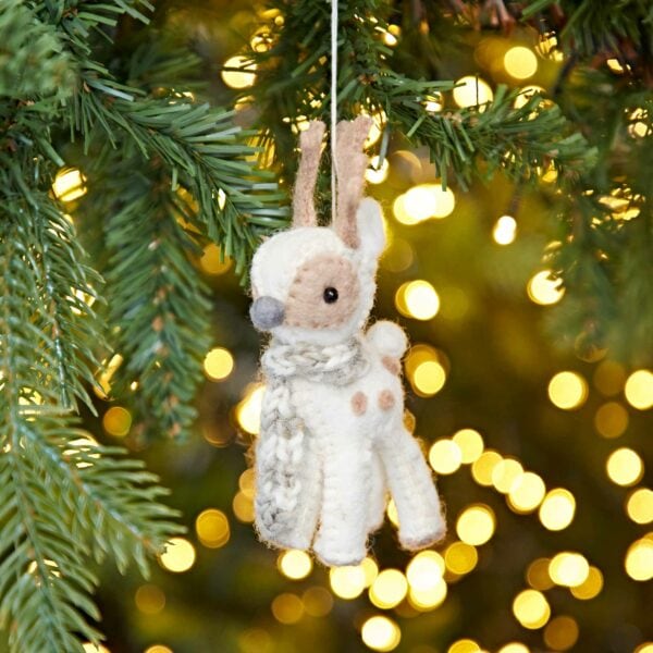A cute Felt Reindeer Christmas Decoration hanging from a tree.