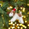 A Felt Christmas Fido Dog Hanging ornament hanging from a Christmas tree.