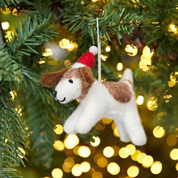 A Felt Christmas Fido Dog Hanging ornament hanging from a Christmas tree.