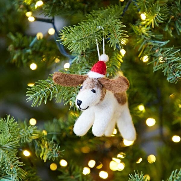 A Felt Christmas Fido Dog Hanging ornament hanging from a Christmas tree.