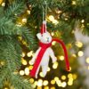 A white felt Felt Christmas Mouse Decoration hanging from a Christmas tree.