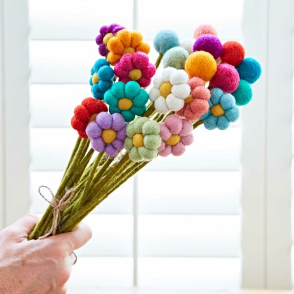 A hand holding a Pack of 6 Felt Handmade Flower Bouquet.