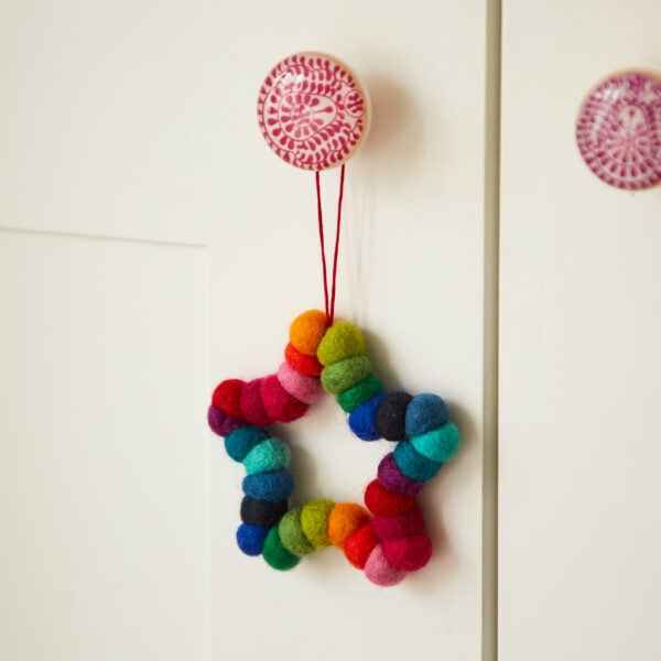 A Felt Multicoloured Decoration hanging on a door.