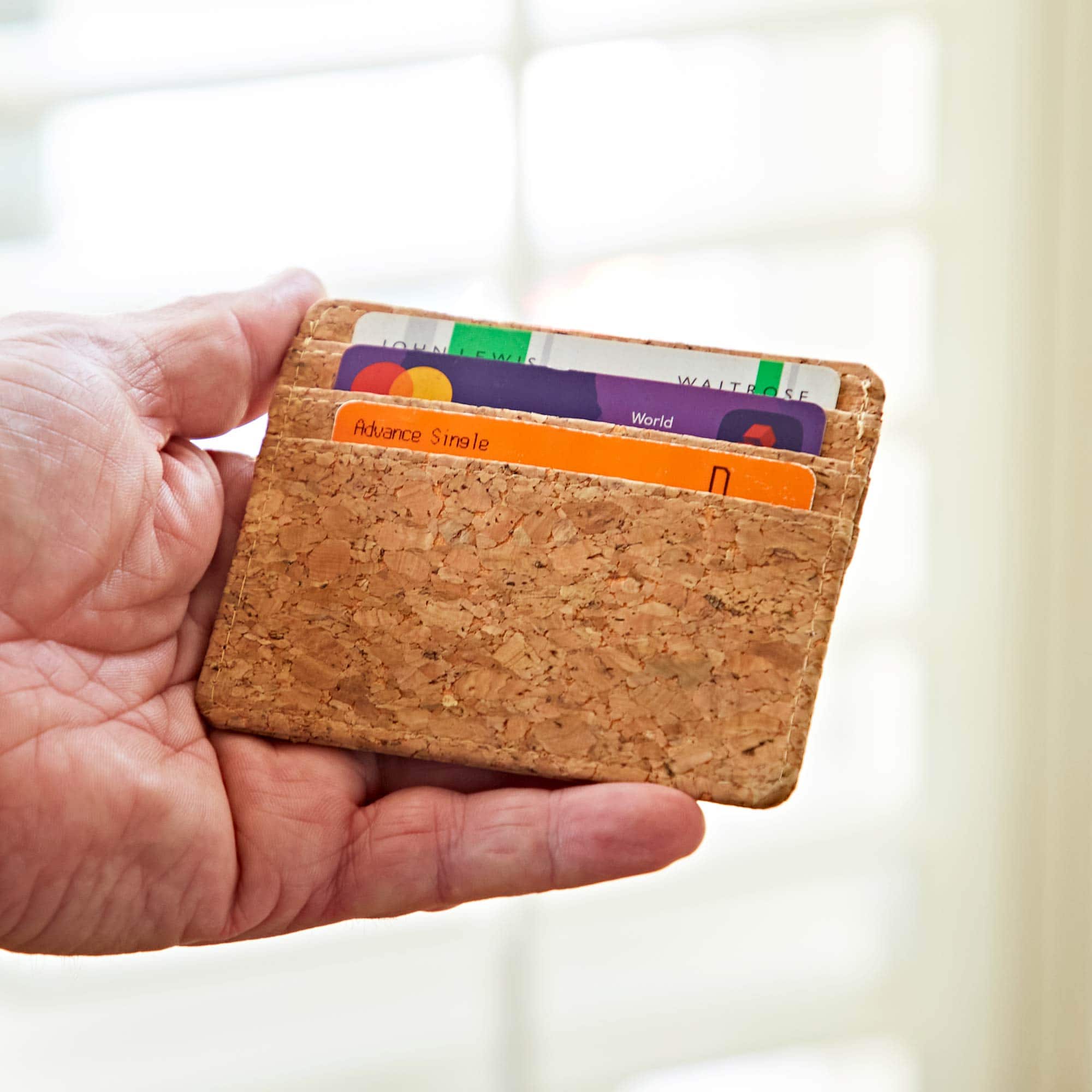 A person holding a Natural Cork Credit Card Holder.