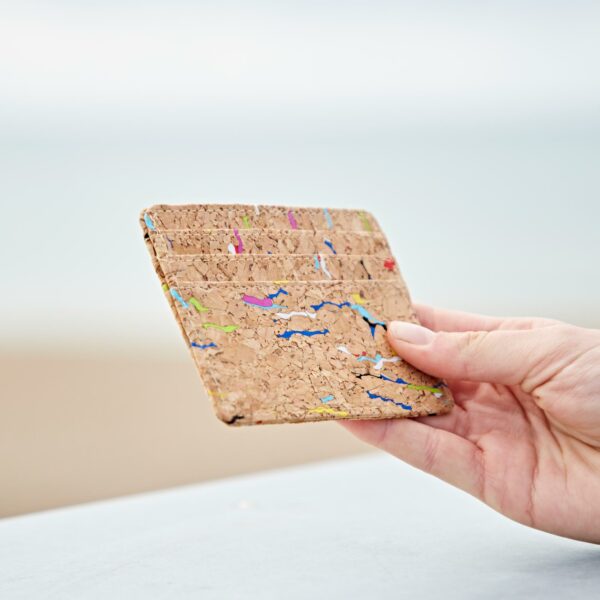 A person holding up their Natural Cork Credit Card Holder.