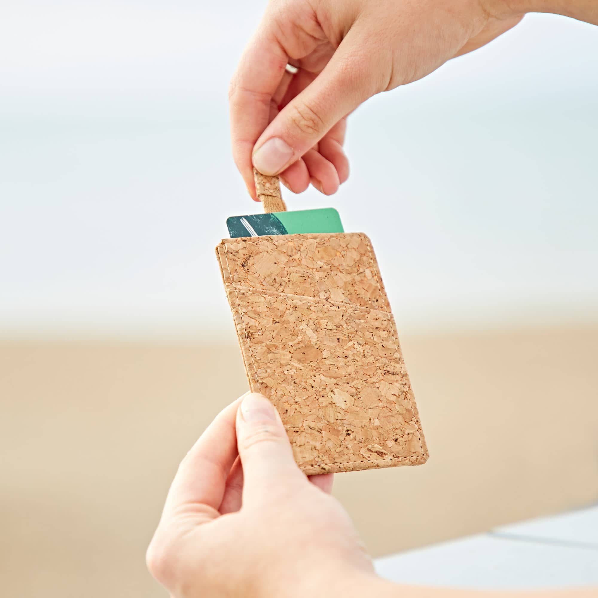 A person displaying their personalised Natural Cork Sliding Credit Card Holder.