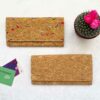 A Natural Cork Clutch Purse with a cactus next to it.