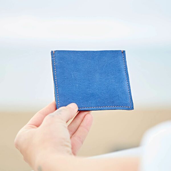 A person holding a Personalised Leather and Suede Credit Card Holder.