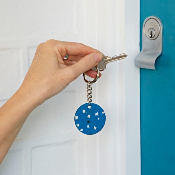 A person opening a blue door.