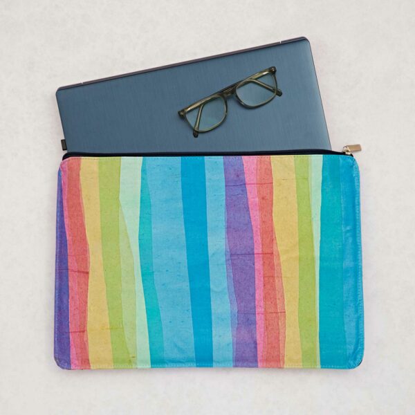 A Recycled Plastic Rainbow 16 inch Laptop Case with glasses and a rainbow striped zipper pouch.