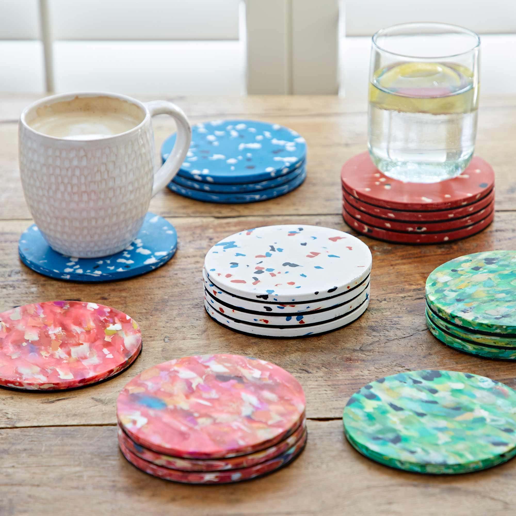 Set of 4 Round Wood and Resin Coasters set on a wooden table.