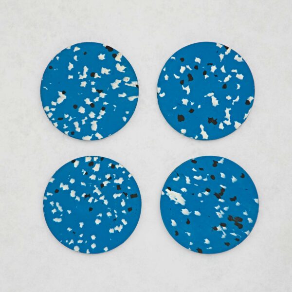 Set of 4 Recycled Round Plastic Coasters: Four round, blue and black splatter coasters on a white surface.