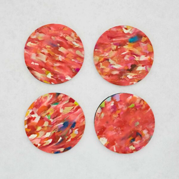 A Set of 4 Recycled Round Plastic Coasters on a white surface.
