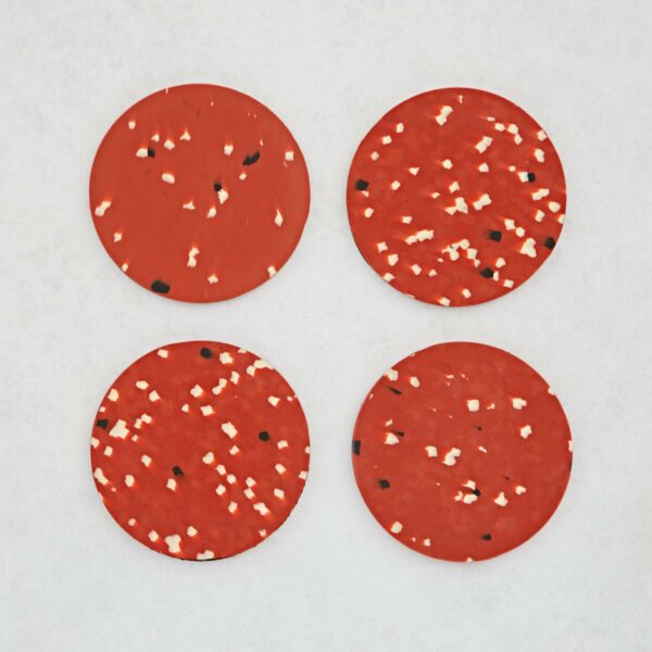 Set of 4 Recycled Round Plastic Coasters with black and white sprinkles.
