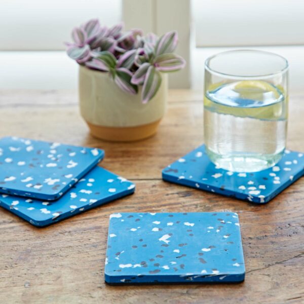 Blue plastic coasters on a wooden table.