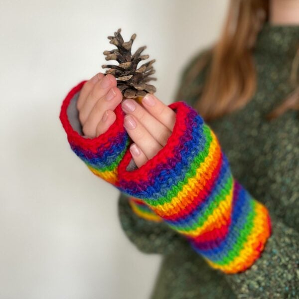 A girl wearing Woollen Rainbow Handwarmer Gloves.
