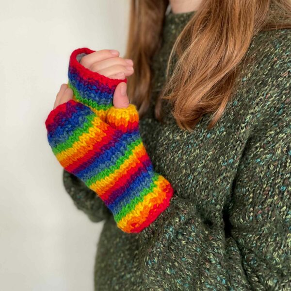 A woman wearing Woollen Rainbow Handwarmer Gloves.