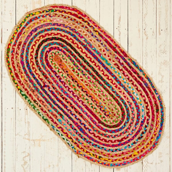 A Multicoloured Jute and Cotton Oval Rag Rug on a wooden floor.