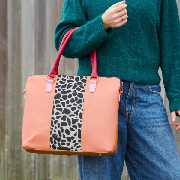 Kiara is holding a bag with a leopard print on it.
