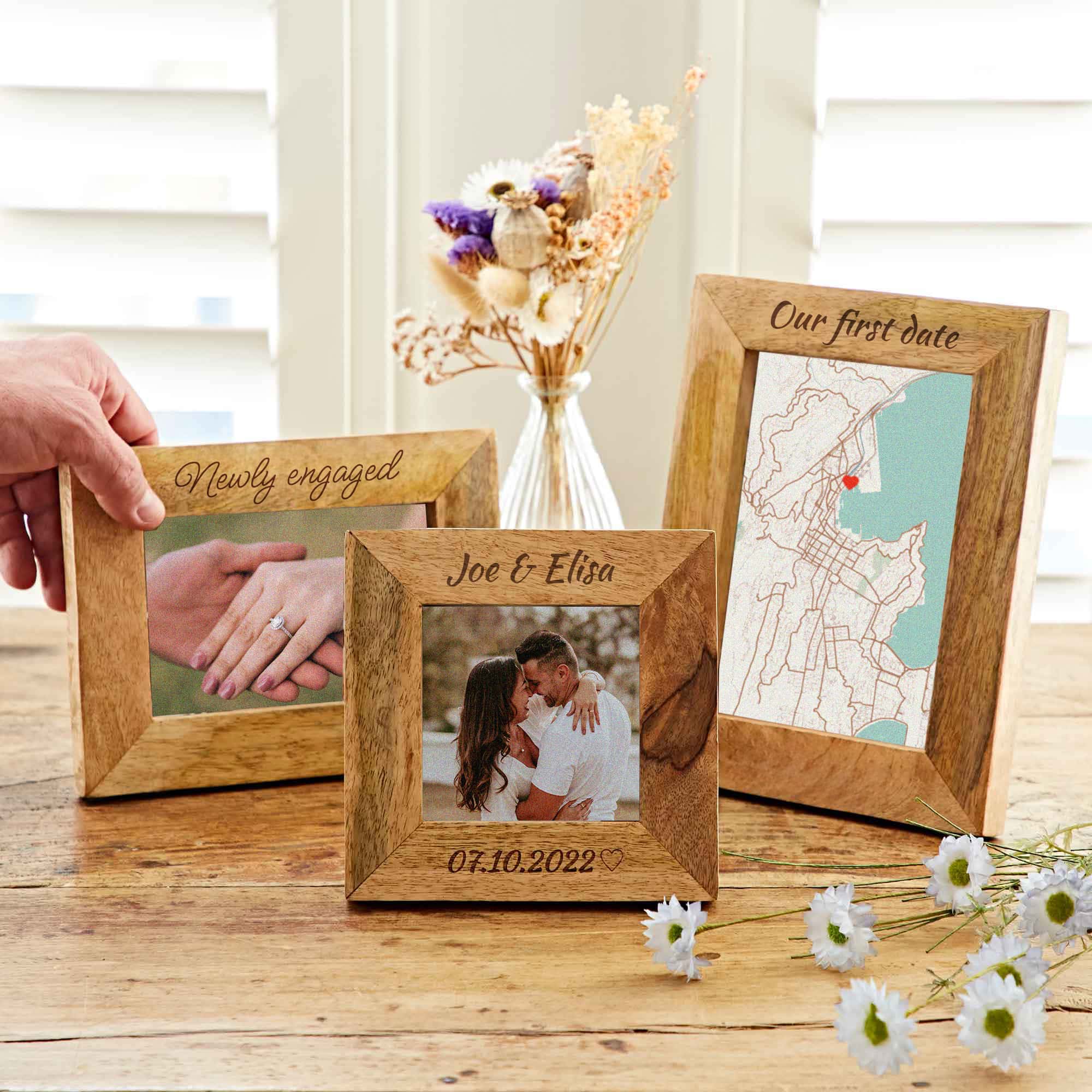 A hand holding a Mother's Day gift picture frame.