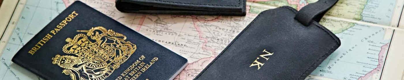British passport and a wallet on a map, highlighting Mother's Day gift travel themes.