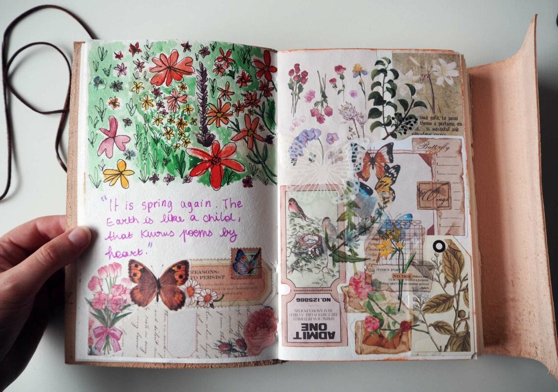 An open scrapbook featuring hand-drawn flowers, butterflies, and collage elements. A handwritten quote on the left page reads: "It is spring again. The Earth is like a child that knows poems by heart." This lovely piece captures the essence of scrapbooking beautifully.
