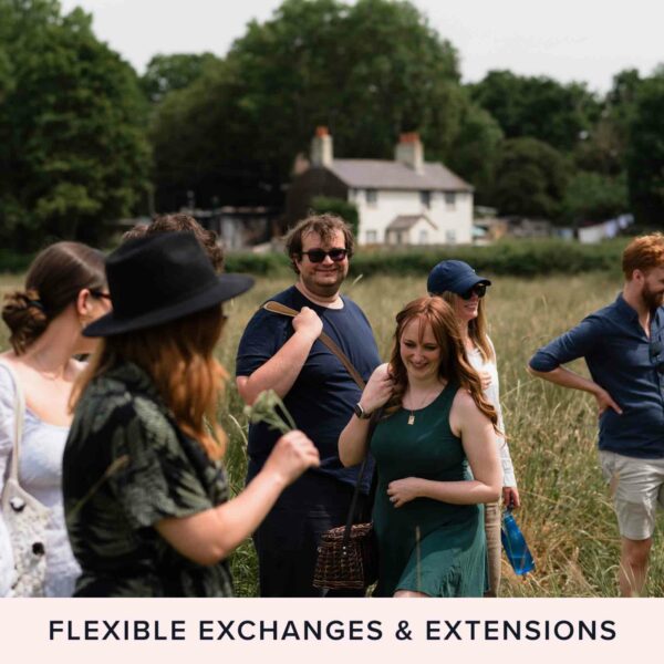 A group of people gathered outdoors in a field, some smiling, under a summer sky. A house and trees are visible in the background. Text reads: "Flexible Exchanges & Extensions with Hiver's Ultimate Beekeeping, Beer and Wine Tasting Experience for Two.