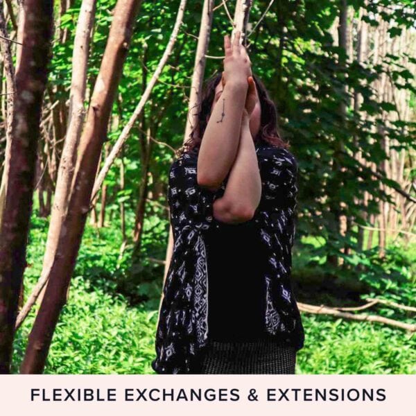 A person stands in a serene forest performing a yoga pose with arms raised overhead, enveloped by the peaceful ambiance of nature. Text at the bottom reads, "Flexible Exchanges & Extensions". Experience the South Downs like never before with our "Tour the South Downs with GPS Guided Full Day Electric Mountain Bike Hire for Two.