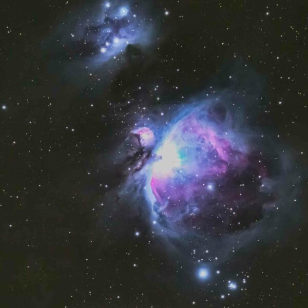 Image of the Orion Nebula, displaying vibrant blue, pink, and purple colors against a dark, star-studded backdrop. Ideal for a Family Visit to Kew Gardens for Two Adults and Two Children (Copy), where the marvels of the universe are brought to life.