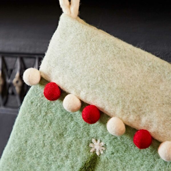 A Felt Christmas Stocking in green with a white top edge, adorned with alternating red and white felt balls.