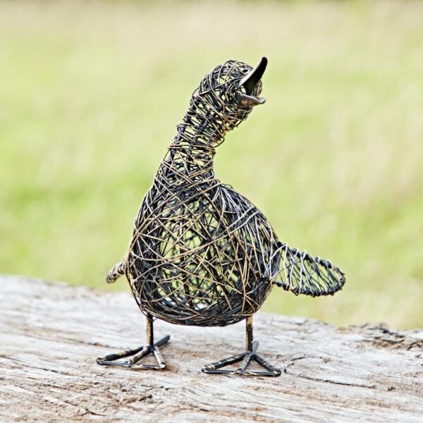 The Small Quacking Duck Wire Garden Ornament features a bird standing on a wooden surface with its beak open against a blurred garden backdrop.