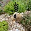The Recycled Metal Harvest Mouse on Wheat Silhouette Garden Stake is a black metal stake with a leaf and harvest mouse design, perfect for placing among rocks, succulents, and garden plants.
