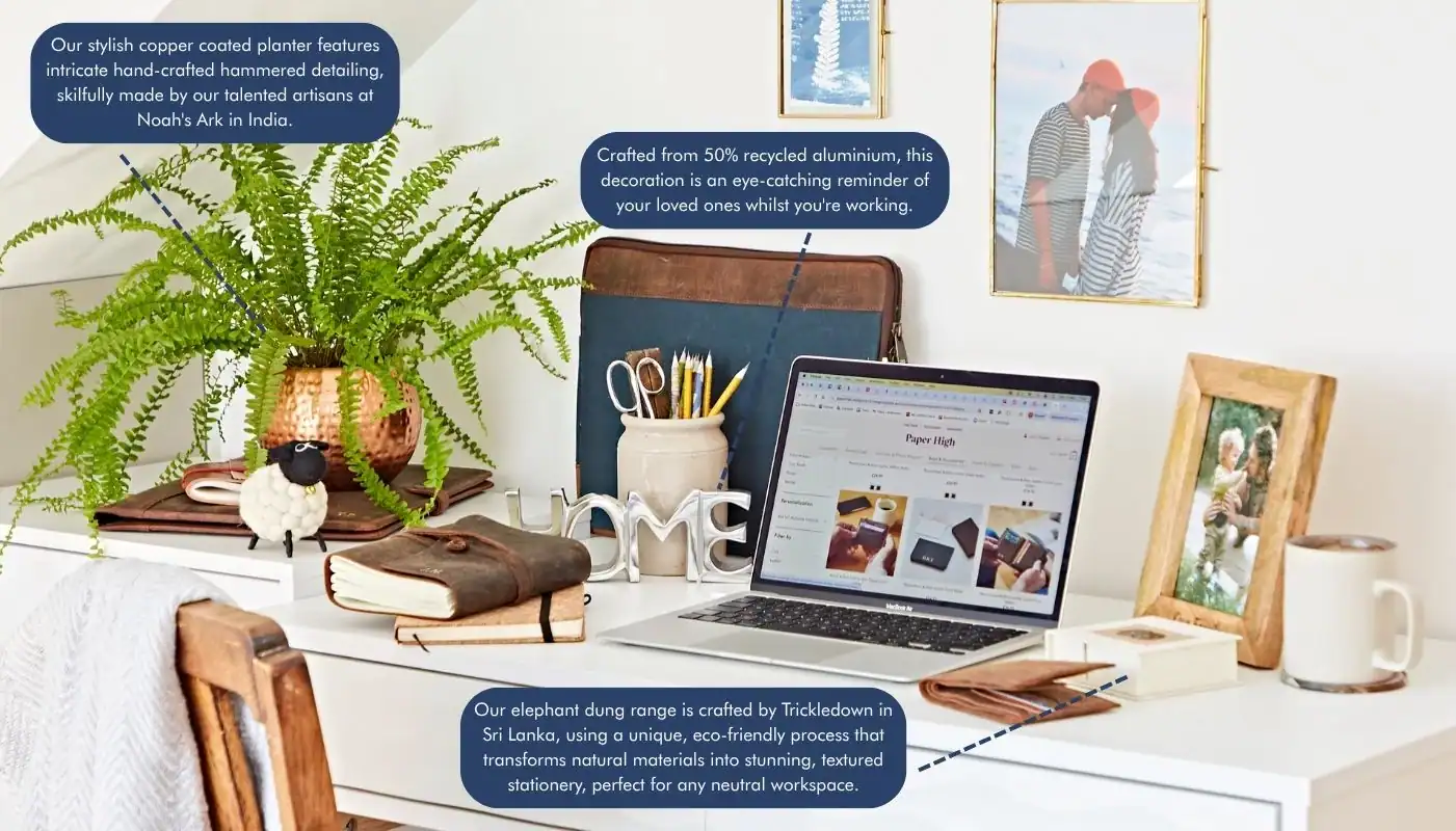 A neatly arranged desk with a laptop, notebooks, a plant in a copper pot, and office supplies embodies The Ultimate Sustainable Home Office Setup, set against a light background with informational text bubbles.