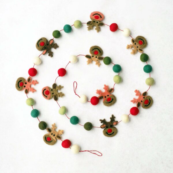The Felt Reindeer Garland features a spiral of festive felt balls, reindeer faces, and snowflakes displayed on a white background.